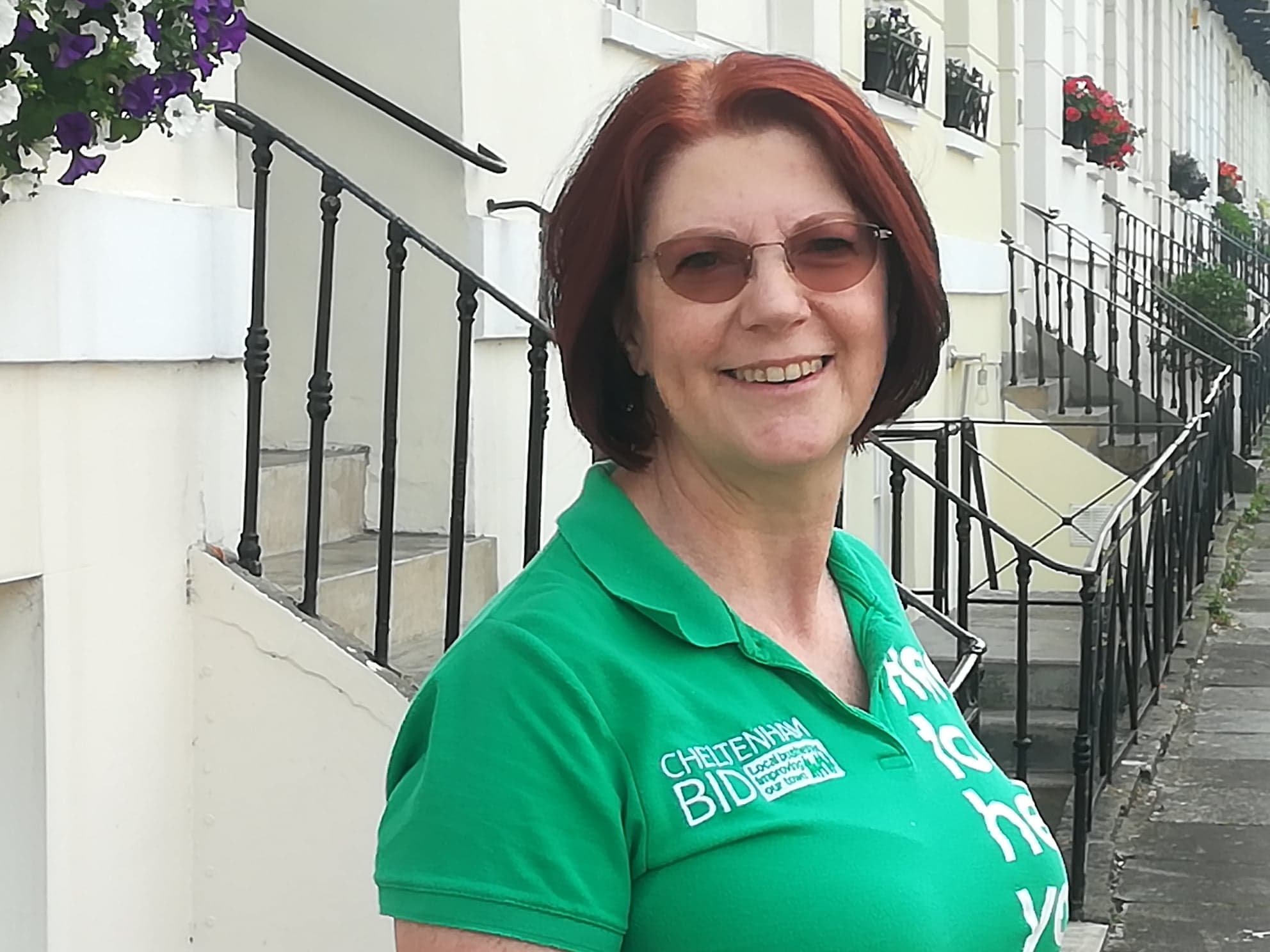 Jo-Anne Hale pictured outside The Logical Ultilities Company in BID green polo shirt with Cheltenham BID logo.
